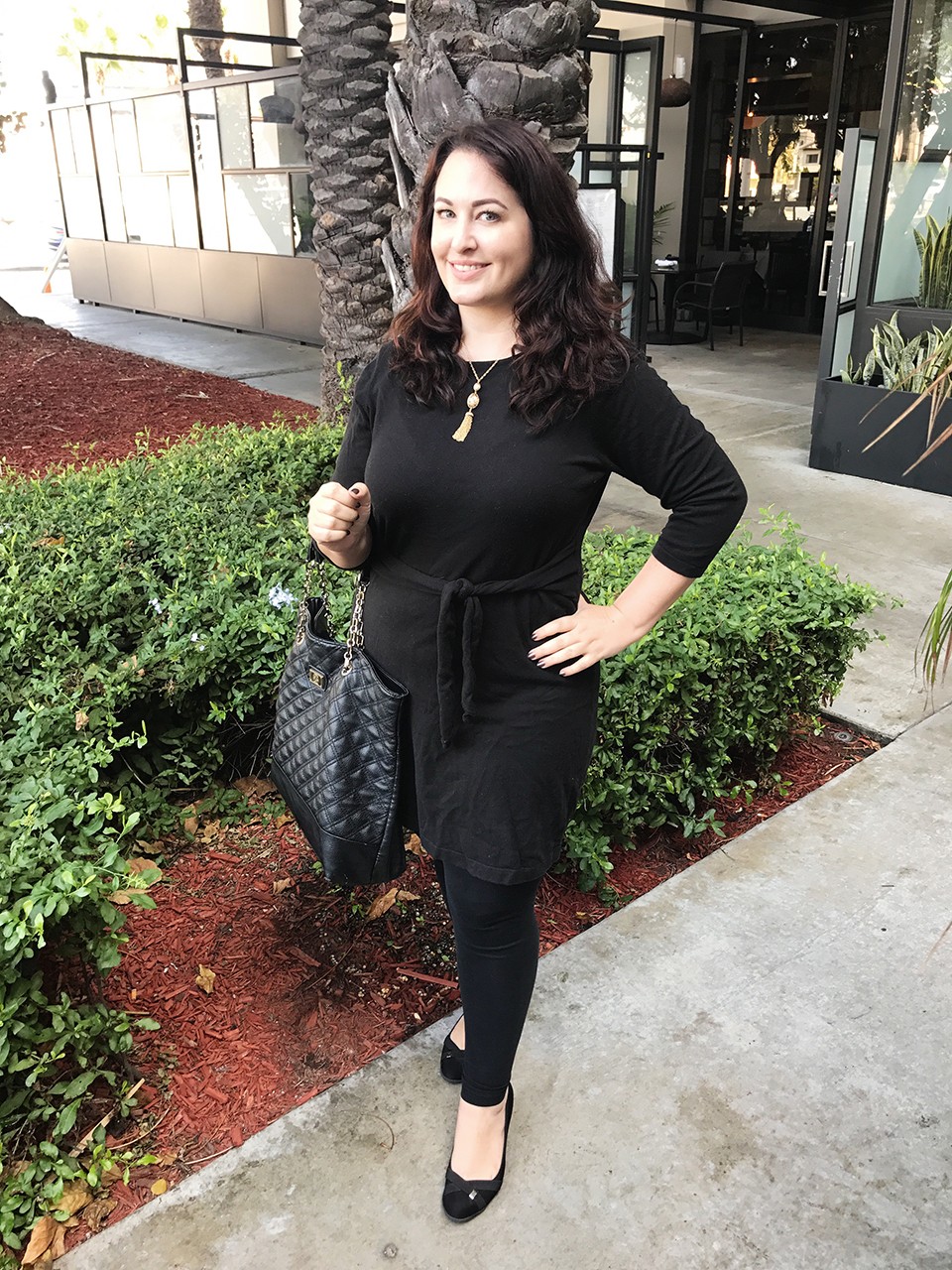 How to dress for a vlogger conference - black wrap dress and Ben Bridge gold tassel necklace